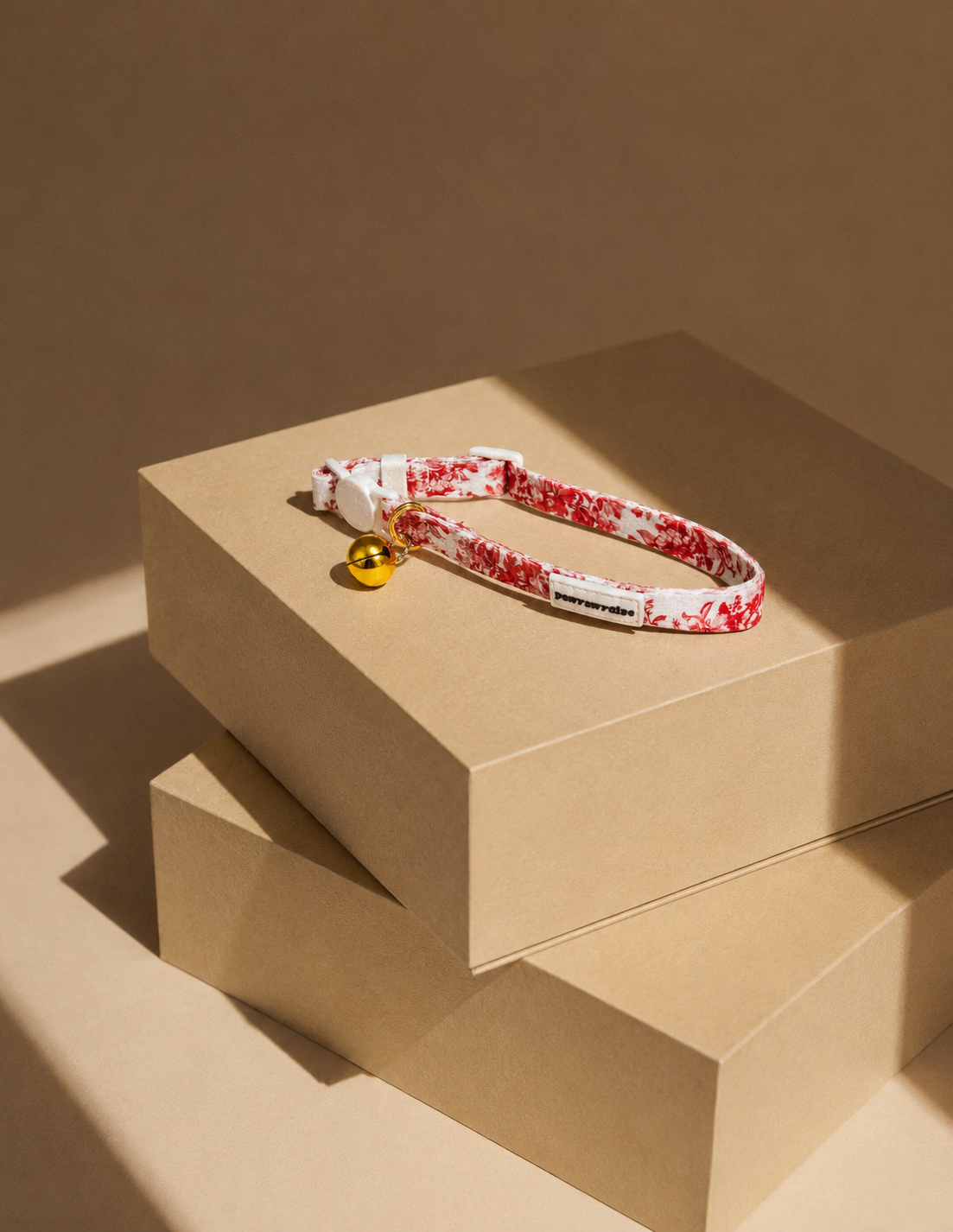 City of Love floral-patterned cat breakaway collar with a bell on a beige surface