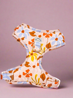 Floral-patterned dog and cat harness on a light purple background